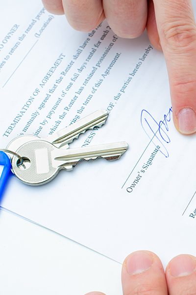 person signing paper next to keys round rock tx